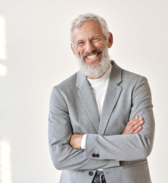 smiling older man dressed in gray suit