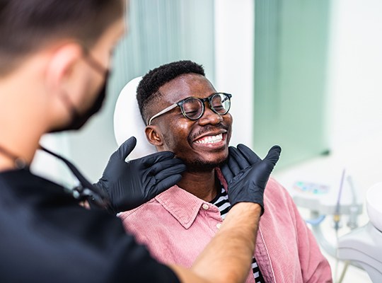 Dentist looking at patient's smile